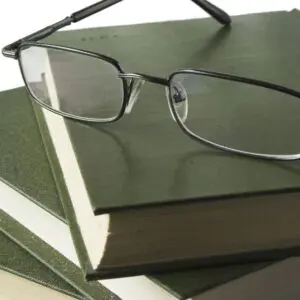 closeup of glasses on the three notebooks