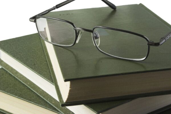 closeup of glasses on the three notebooks